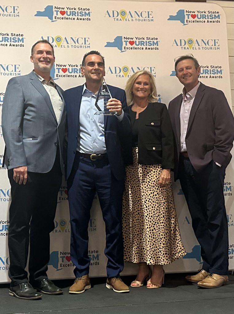 Tom Martinelli (center) accepting the NYSTIA Tourism Excellence Award, Lake George, NY, September 2025.